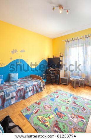 Interior of a kid-room with furniture and two colors painted walls.