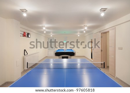 Interior of an entertainment room, billiard and tennis table details.