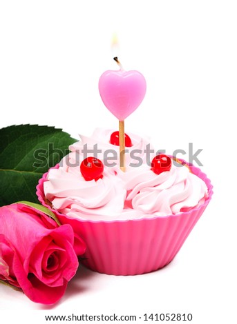 Tasty anniversary cupcake with candle, on white background