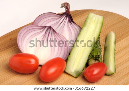 salted cucumber, red cherry tomatoes and sliced red onion Bamboo cutting board
, traditional snack while drinking vodka