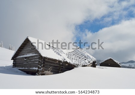 Winter landscape with old wooden destroyed house. Shepherds hut in a mountain valley. Carpathians, Ukraine, Europe
