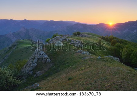 Mountain landscape with a beautiful sunset. Camping in the outdoors with a tent. The peninsula of Crimea, Ukraine, Europe