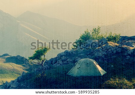Morning landscape with a tent. Camping in the Spring Mountains. Filtered image: vintage, grunge and texture effects