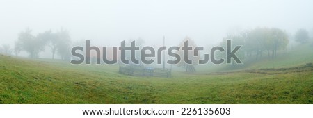 Rural landscape with fog. Autumn in the mountains. Panoramic view of the yard garden. Carpathians, Ukraine, Europe