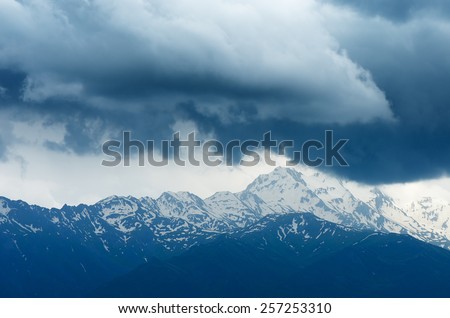 Snowy mountain ridge in the clouds. Georgia, Svaneti ridge