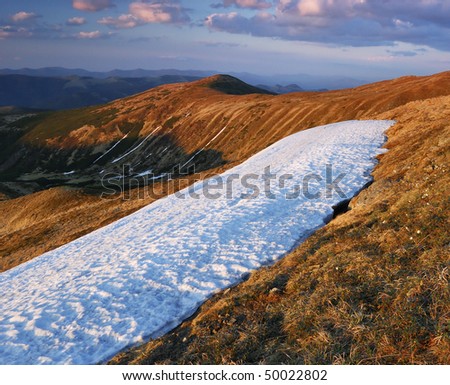 Spring in mountains and last snow. The Ukrainian mountains Carpathians