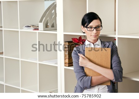 business woman holding folder for papers and looking at camera. Copy space