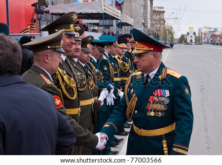 NOVOSIBIRSK - MAY 9: Commander of the 41st Army, Vasiliy Tonkoshkurov, congratulates the commander  on parade of victory dedicated to 66th of victory in World War II on May 9, 2011, Novosibirsk Russia
