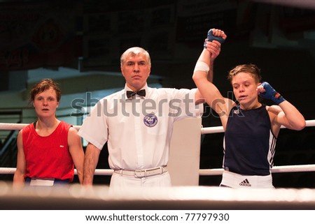 NOVOSIBIRSK - MAY 20: Russian Championship in women\'s boxing. Referee declares winner on semi-final battle between  Makarova Anastasiya(red) Gladkova Olesya(blue) on May 20, 2011 Novosibirsk Russia
