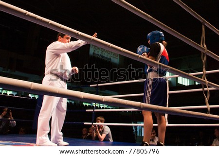 NOVOSIBIRSK - MAY 20: Russian Championship in women\'s boxing. The semi-final battle.  referee believes knockdown for Sablina Yuliya(blue) on May 20, 2011, Novosibirsk Russia