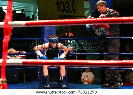NOVOSIBIRSK - MAY 21: Russian Championship in women\'s boxing. The final battle  The coach sets up and gives instructions. Gladkova Olesya(blue) and her coach. May 21, 2011, Novosibirsk Russia