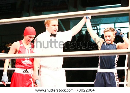 NOVOSIBIRSK - MAY 21: Russian Championship in women\'s boxing. Referee declares winner on final battle between Savelieva Elena(red) Gladkova Olesya(blue) on May 21, 2011, Novosibirsk Russia