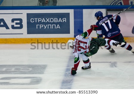 NOVOSIBIRSK - SEPTEMBER 26:  Ice hockey, the game between Siberia and AK Bars, forward Tereshchenko (AkB) falls on the ice against the forward Kryukov (Sib) on September 26, 2011, Novosibirsk Russia
