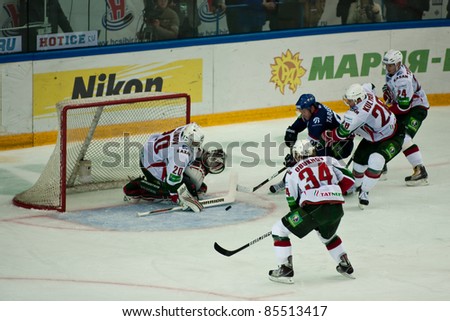 NOVOSIBIRSK - SEPTEMBER 26:  Ice hockey, the game between Siberia and AK Bars The attack on the gate Ak Bakrs goalkeeper Stanislav Galimov taps the puck on September 26, 2011, Novosibirsk Russia
