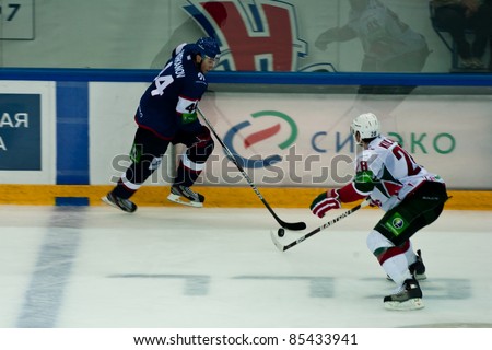 NOVOSIBIRSK, RUSSIA - SEPTEMBER 26:Ice hockey game between Siberia and AK Bars with defender Denis Kulyash (AK Bars) and forward Timofei Shishkanov (Siberia) on September 26, 2011, Novosibirsk Russia