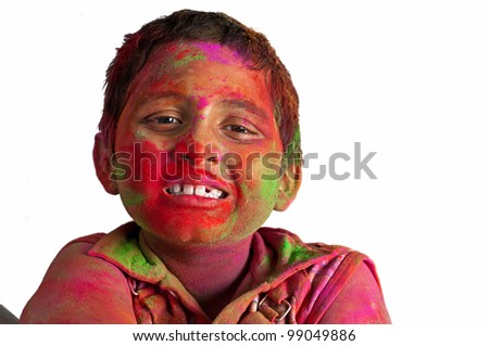 Close up face of young boy playing Holi, smiling with colors on face, White Background, Happy child