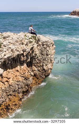 fisherman at the cliff border , Cantabria, Spain