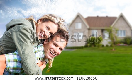 Happy family near new house. Real estate concept.