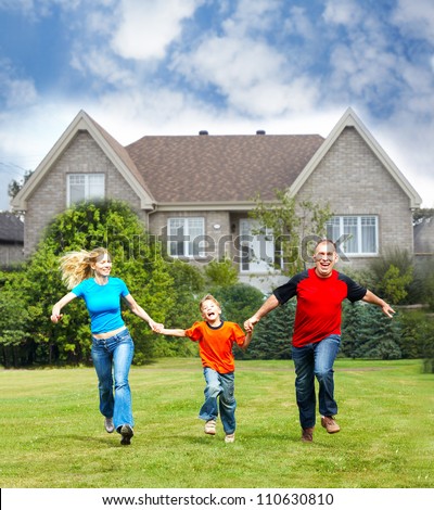 Happy family near new house. Real estate concept.