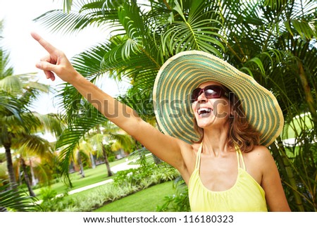 Woman in the tropical garden. Vacation.