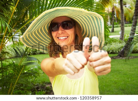 Happy woman in the tropical garden. Vacation.