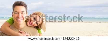 Happy couple on the beach. Exotic luxury resort.