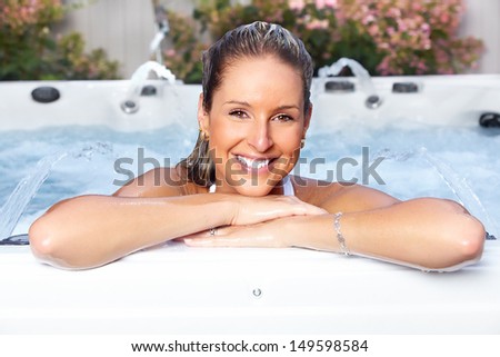 Beautiful woman relaxing in a hot tub. Vacation.