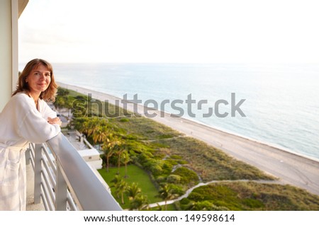 Woman on a balcony at Miami beach hotel.