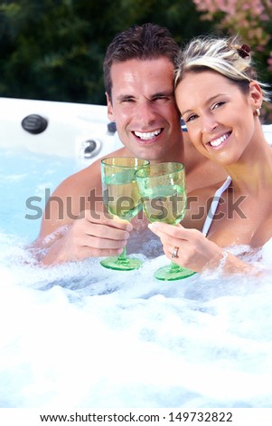 Happy couple relaxing in hot tub. Vacation.