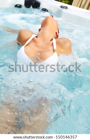 Beautiful woman relaxing in a hot tub. Vacation.