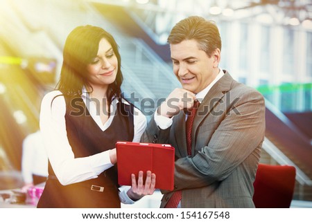 Businessman and businesswoman in modern office,
