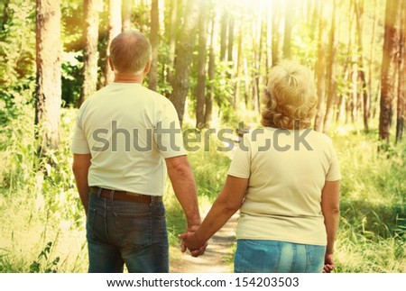 Senior couple walking in park. Elderly people life.
