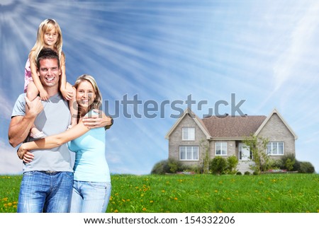 Happy family near new home. Real estate background.