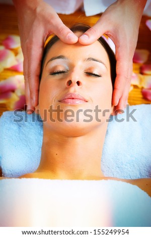 Beautiful woman having anti wrinkle face massage.