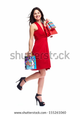 Young happy smiling woman with shopping bags, isolated over white background