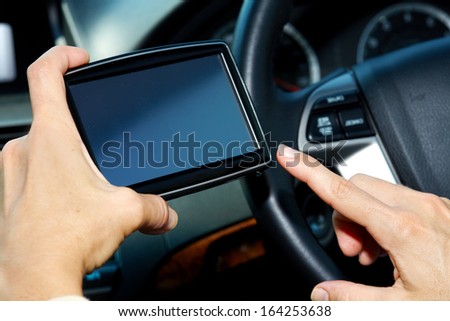 Car driver hands with GPS. Road destination.