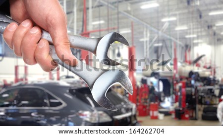 Hand of professional Auto mechanic with wrench.