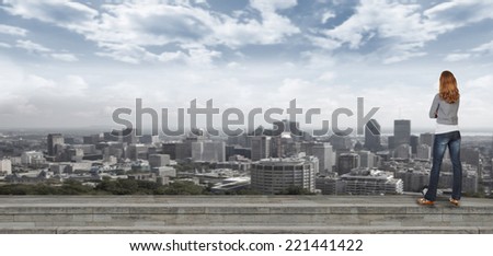 Woman looking at urban landscape. Business strategy concept