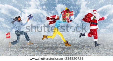 Group of Happy people running with Xmas gifts. Christmas.