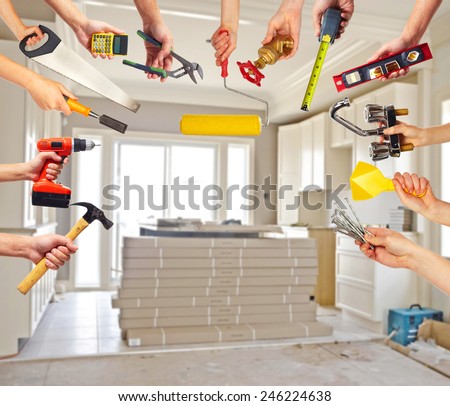 Hands with construction tools. House Renovation background.