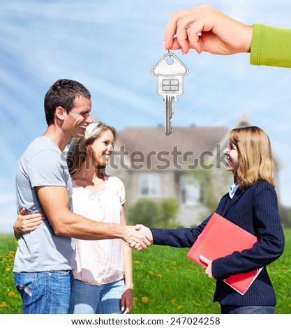 Happy Family near new home. Residential construction background.