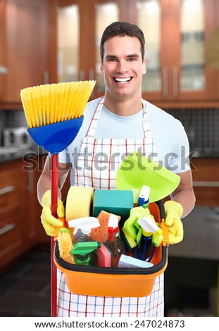 cleaner man with a broom in modern house.