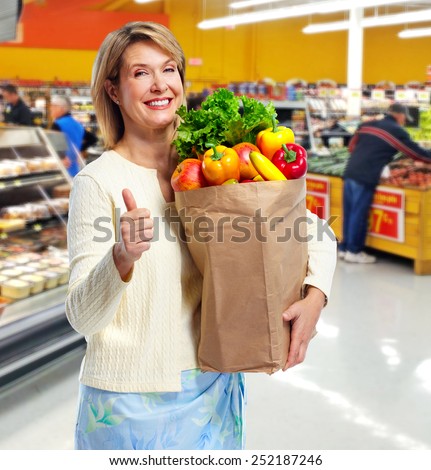 Senior shopping woman with grocery items. Healthy diet.