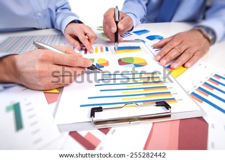 Hands of business people working in office with documents.