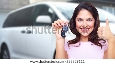 Woman holding a car key. Auto repair service
