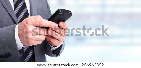 Hands of businessman with phone. Technology and communication background.