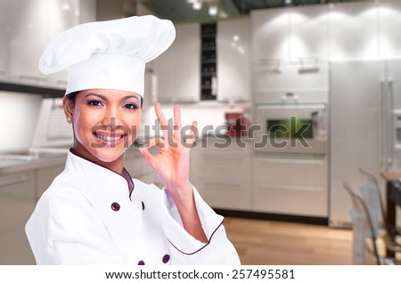 Smiling chef woman in a modern kitchen