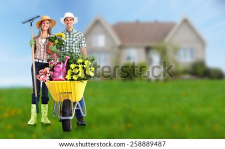 Gardening people. Couple with flowers in the garden.