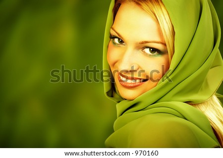 Attractive blonde with lovely makeup on green background. Great pic for advertising.