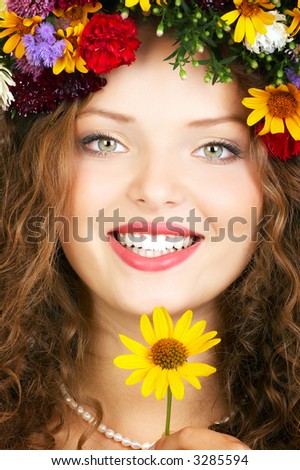 Beautiful young woman wearing a flower  diadem.